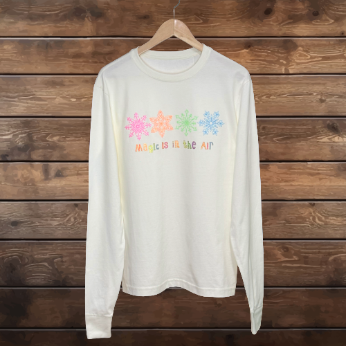 Pastel, glitter snowflakes in a row. Metallic gold outlined words. Magic is in the Air in Pastel glitter colors.